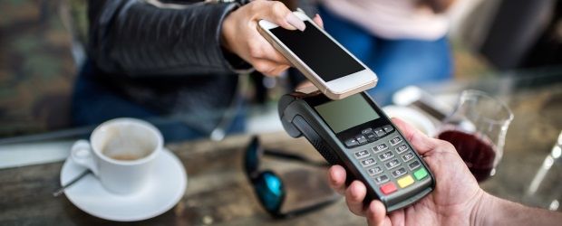 Customer making a mobile payment at a retail counter